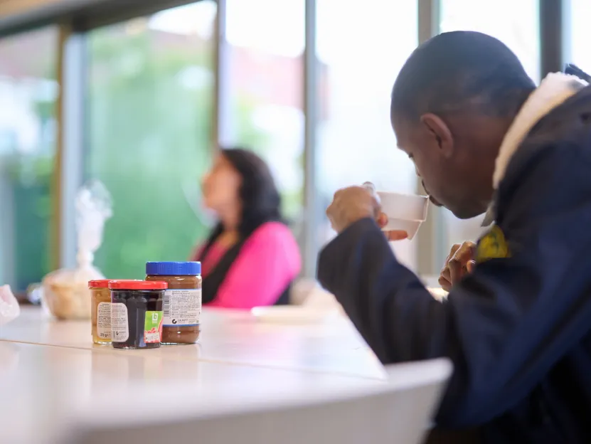 Dakloze drinkt koffie
